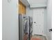 Laundry room with front loading washer and dryer and overhead storage space at 9390 N 115Th St, Scottsdale, AZ 85259