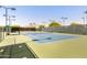 Well-maintained blue and green outdoor tennis court with lighting for night play at 9390 N 115Th St, Scottsdale, AZ 85259