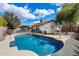 Private backyard features a sparkling pool, covered patio, desert landscaping, and a basketball hoop for entertainment at 1002 E Grandview Rd, Phoenix, AZ 85022