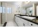 Modern bathroom featuring dual sinks, a large mirror, and a walk-in shower at 1002 E Grandview Rd, Phoenix, AZ 85022