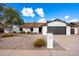 Charming single-story home with a well-maintained xeriscaped front yard and a two-car garage at 1002 E Grandview Rd, Phoenix, AZ 85022