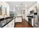 Modern kitchen with stainless steel appliances, white cabinets, and a breakfast bar at 1002 E Grandview Rd, Phoenix, AZ 85022