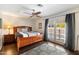 Spacious main bedroom with hardwood floors, ceiling fan, and access to the backyard at 1002 E Grandview Rd, Phoenix, AZ 85022