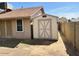 View of backyard showing shed with ample space and block fence perimeter at 10250 N 65Th N Ave, Glendale, AZ 85302
