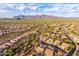 Aerial view of a planned community with homes and desert landscape against a mountain backdrop at 10356 E Meandering Trail Ln, Gold Canyon, AZ 85118