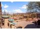 Tranquil backyard showcasing a unique water feature, desert landscaping, and beautiful mountain views in the distance at 10356 E Meandering Trail Ln, Gold Canyon, AZ 85118