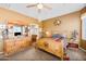 Well-lit bedroom with natural wood furniture, carpeted floors, and a connected bathroom at 10356 E Meandering Trail Ln, Gold Canyon, AZ 85118