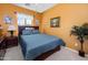 Cozy bedroom features a queen-size bed, floral accents, and a ceiling fan at 10356 E Meandering Trail Ln, Gold Canyon, AZ 85118