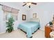 Bright bedroom with a light blue quilt, carpeted floors, and a ceiling fan at 10356 E Meandering Trail Ln, Gold Canyon, AZ 85118