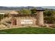 Entrance sign for Peralta Trails, a Primary-planned community with desert landscaping at 10356 E Meandering Trail Ln, Gold Canyon, AZ 85118