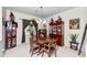 Warm dining room featuring a wooden table, china cabinets, and tasteful decor at 10356 E Meandering Trail Ln, Gold Canyon, AZ 85118