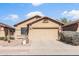 Charming single-story home with a well-manicured front yard, desert landscaping, and attached two-car garage at 10356 E Meandering Trail Ln, Gold Canyon, AZ 85118