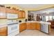Well-equipped kitchen with oak cabinets, white appliances, and an open layout at 10356 E Meandering Trail Ln, Gold Canyon, AZ 85118