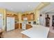 Clean kitchen with oak cabinets, white appliances, and tile flooring at 10356 E Meandering Trail Ln, Gold Canyon, AZ 85118