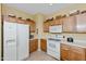 Functional kitchen with white appliances, tile backsplash, and ample cabinet space at 10356 E Meandering Trail Ln, Gold Canyon, AZ 85118