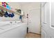 Bright laundry room featuring washer, dryer, storage shelf, and easy access to the outdoors through the door at 10356 E Meandering Trail Ln, Gold Canyon, AZ 85118