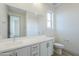 Bright bathroom features a double sink vanity, a large mirror, and neutral finishes at 12698 N 153Rd Ave, Surprise, AZ 85379