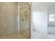 Modern bathroom with a glass-enclosed shower featuring neutral tile and a tiled floor at 12698 N 153Rd Ave, Surprise, AZ 85379
