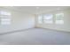 Spacious bedroom featuring plush carpet and multiple windows offering natural light at 12698 N 153Rd Ave, Surprise, AZ 85379