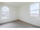 Bright bedroom with natural light, featuring two large windows with views and carpet flooring at 12698 N 153Rd Ave, Surprise, AZ 85379