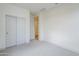 Cozy bedroom featuring neutral carpet, white walls, and a closet with sliding doors, providing storage at 12698 N 153Rd Ave, Surprise, AZ 85379