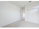 Bright, neutral bedroom featuring carpet, white walls and trim, and large closet with sliding doors at 12698 N 153Rd Ave, Surprise, AZ 85379