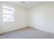 Simple bedroom with carpeted flooring, white walls, and a window overlooking the exterior at 12698 N 153Rd Ave, Surprise, AZ 85379