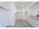 A spacious walk-in closet with carpet flooring and multiple rows of white shelving and metal rods at 12698 N 153Rd Ave, Surprise, AZ 85379