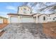 Exterior view of a charming two-story home featuring a paver driveway and three-car garage at 12698 N 153Rd Ave, Surprise, AZ 85379