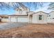 Exterior view of a charming two-story home featuring a paver driveway and three-car garage at 12698 N 153Rd Ave, Surprise, AZ 85379