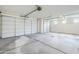 Spacious three-car garage featuring sealed concrete flooring and automatic overhead doors at 12698 N 153Rd Ave, Surprise, AZ 85379