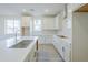 Bright kitchen featuring white cabinets, subway tile backsplash, and modern fixtures at 12698 N 153Rd Ave, Surprise, AZ 85379
