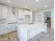 Spacious kitchen with an island, white cabinets, and stainless steel fixtures at 12698 N 153Rd Ave, Surprise, AZ 85379