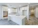 Bright kitchen with white cabinets, subway tile backsplash, and a large center island with quartz countertop at 12698 N 153Rd Ave, Surprise, AZ 85379