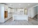 Spacious kitchen featuring a kitchen island, adjacent to stairs and dining room at 12698 N 153Rd Ave, Surprise, AZ 85379