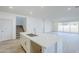 Spacious kitchen featuring a kitchen island, adjacent to stairs and dining room at 12698 N 153Rd Ave, Surprise, AZ 85379