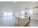 Open-concept kitchen with white cabinets and center island at 12698 N 153Rd Ave, Surprise, AZ 85379