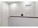 Updated bathroom showcasing a modern shower with glass doors and white tile walls at 13614 N 38Th Pl, Phoenix, AZ 85032