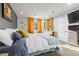 Comfortable bedroom features a large bed, two windows and a gray accent wall at 13614 N 38Th Pl, Phoenix, AZ 85032