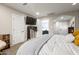 Bedroom with TV, dresser and sitting chair, leading to ensuite bath with stylish finishes at 13614 N 38Th Pl, Phoenix, AZ 85032