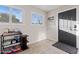 Entryway with a dark front door, tile flooring, and shelves for added storage and decor at 13614 N 38Th Pl, Phoenix, AZ 85032