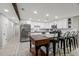 Open kitchen with stainless steel refrigerator and oven, white cabinets, and island with seating at 13614 N 38Th Pl, Phoenix, AZ 85032