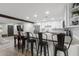 Kitchen island with barstool seating and butcher block counter, open to the living area at 13614 N 38Th Pl, Phoenix, AZ 85032