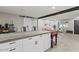 Open-concept living and kitchen area, with a view of the kitchen island and seating at 13614 N 38Th Pl, Phoenix, AZ 85032