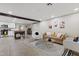 Spacious living room featuring modern décor, comfortable seating, and an open layout with a view into the kitchen at 13614 N 38Th Pl, Phoenix, AZ 85032