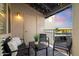 Cozy balcony with string lights, comfortable seating and neighborhood views during sunset at 14145 N 92Nd St # 2077, Scottsdale, AZ 85260