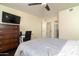 Relaxing bedroom with a ceiling fan, television, and convenient access to the stairway at 14145 N 92Nd St # 2077, Scottsdale, AZ 85260
