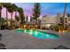 Stunning community pool with a hot tub, poolside lounge chairs, and mature palm trees at 14145 N 92Nd St # 2077, Scottsdale, AZ 85260