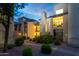 Charming condo exterior with landscaped grounds and cozy balcony lighting at 14145 N 92Nd St # 2077, Scottsdale, AZ 85260