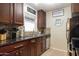 Galley kitchen featuring dark countertops, and stainless steel appliances at 14145 N 92Nd St # 2077, Scottsdale, AZ 85260